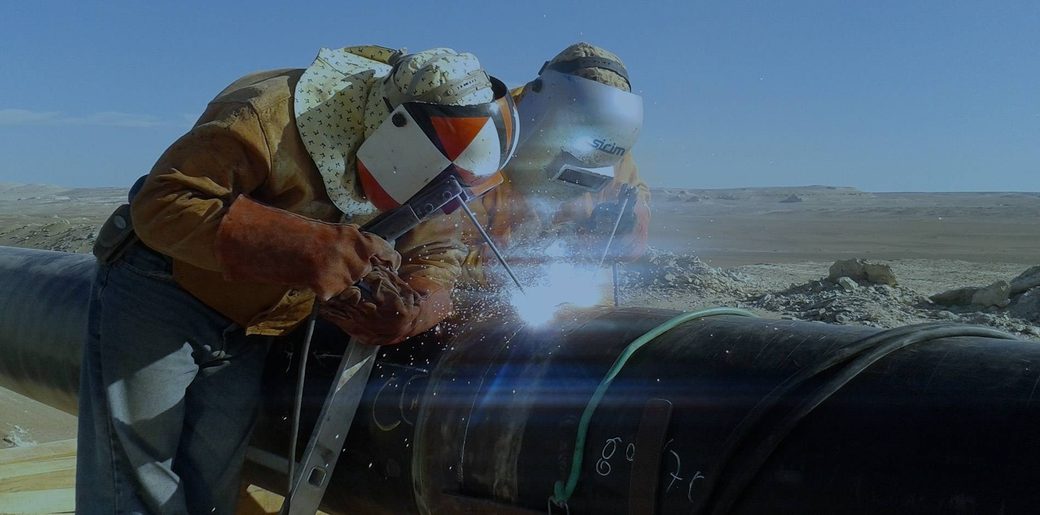 Two SICIM welders joining a section of pipeline on site.
